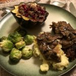 A plant-based Thanksgiving feast: Lentil loaf, stuffed acorn squash, maple-Dijon roasted brussel sprouts topped with mushroom gravy.