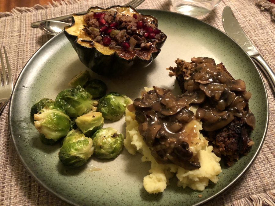 A plant-based Thanksgiving feast: Lentil loaf, stuffed acorn squash, maple-Dijon roasted brussel sprouts topped with mushroom gravy.